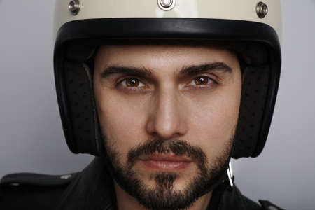 Close up portrait of young and handsome biker looking at the camera.の写真素材