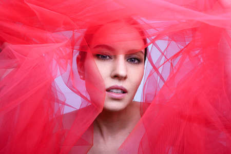 Close-up portrait of stylish young woman posing in the studio.