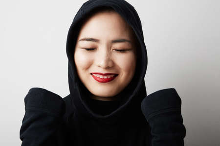 Young muslim asian woman posing on the white background and smile. Isolated.の写真素材