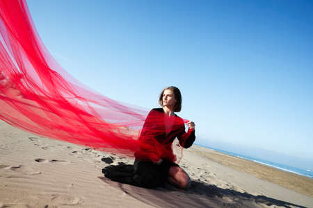 Young woman enjoying sunny weather on the beach.の写真素材