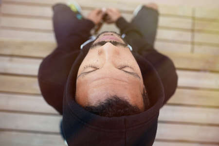 Young black man sitting on the playground and relax. Horizontal.の写真素材