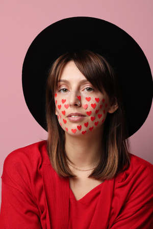 Vertical close-up portrait of young woman celebrating San Valentines Day. Relationship concept.の写真素材