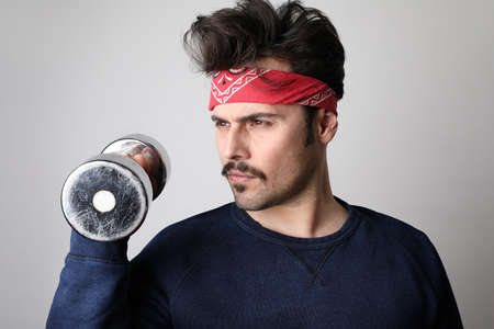 Young hipster man with moustache doing exercise.