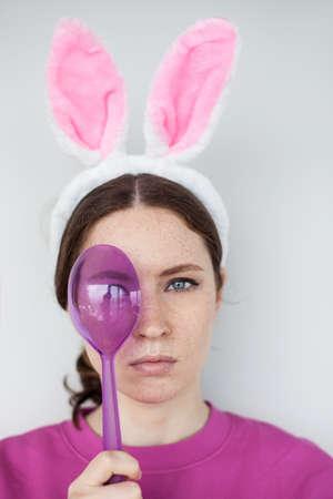 Portrait of young woman wearing bunny ears. Vertical image.