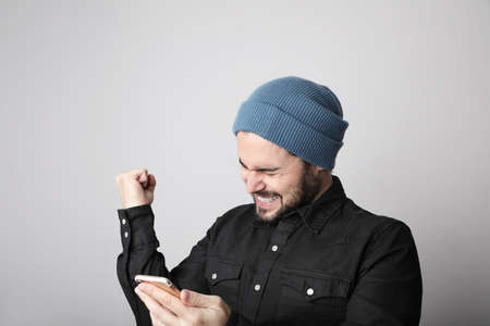 Young bearded hipster blogger posing on the white background. Isolatedの写真素材