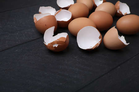 Many eggs on the table for cooking. Baking ingredients on dark wooden table.