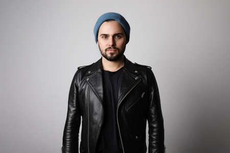 Bearded hipster wearing stylish hat on head. Brutal man with mustache and beard on unshaven bearded face.の写真素材