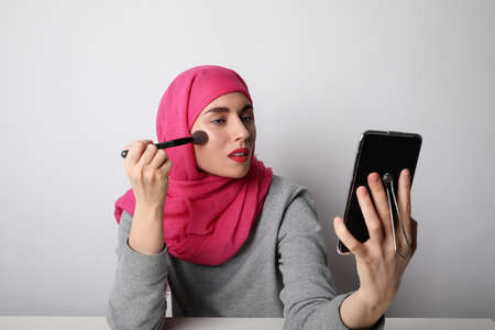 Close-up portrait of charming Muslim woman wearing make-up. Horizontal.