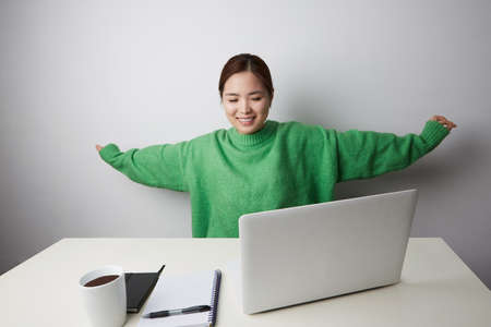 Happy asian young woman studying using laptop. SME entrepreneur or freelance life style concept.の写真素材