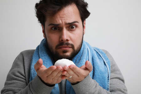 Handsome bearded man with beard holding shaving foam. Male grooming concept.の写真素材