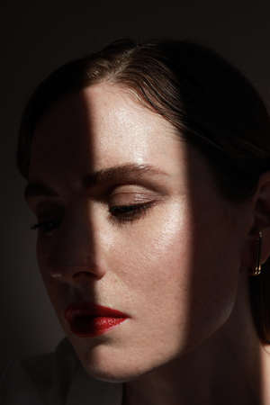 Attractive young woman with red lips. Vertical close-up of beautiful woman.の写真素材