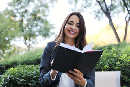 Young business woman smiling outdoor, wearing a suit.の写真素材