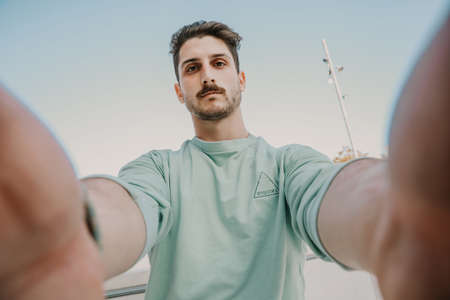 Portrait of caucasian young man posing outdoor. City life style.の写真素材