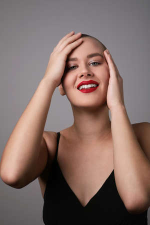 Vertical portrait of a happy, beautiful and bald woman.