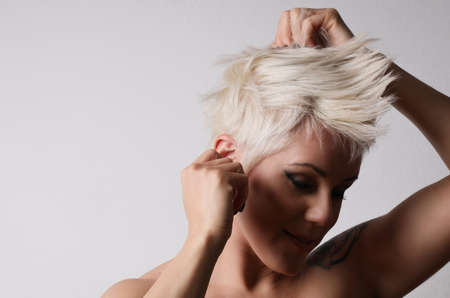 Beauty portrait of fashion young woman with short blonde hair.の写真素材