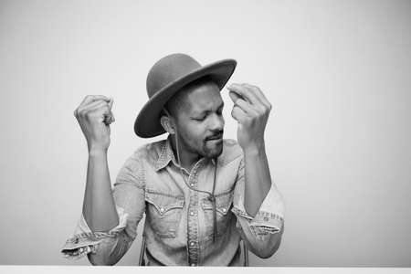 Black young man with coffee cup posing isolated in studio. Black and white.の写真素材