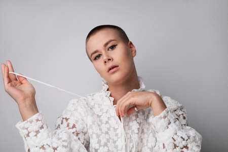 Beautiful young bald woman, posing in the studio. Isolated.の写真素材