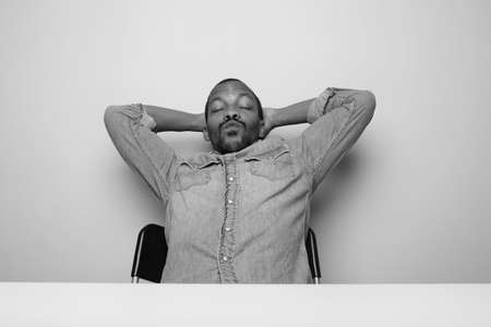 Black young man making fun and silly things. Black and white.の写真素材