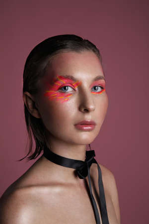 Vertical headshot of woman with bright eyeshadow make-up. Isolated.