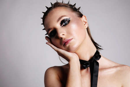 Close-up portrait of beautiful young woman with creative make-up. Isolated.