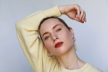 Positive caucasian female model posing on white background. Isolated.の写真素材