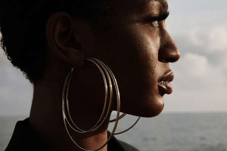 Cropped portrait of afro black woman with short hair. Outdoor.の写真素材
