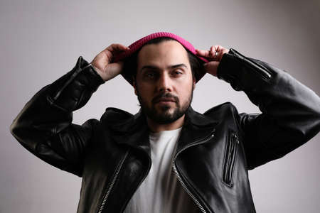 Handsome bearded man, confident attitude, posing over white wall. Isolated.