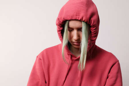 Portrait of young happy woman with colourful hair wears hood on her head.の写真素材