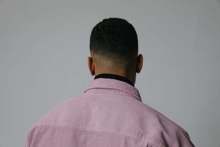 Back view of young Black guy with mental issues. Isolated on white background.の写真素材