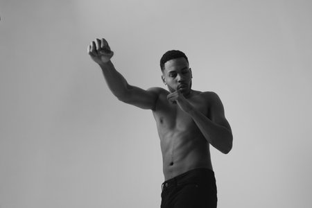 Confident young black man boxer practicing boxing isolated in studio.の写真素材