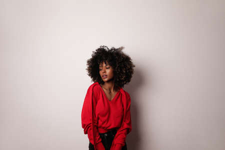 Happy African American young woman smiling and posing on white background.の写真素材
