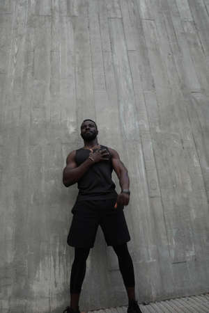 Full-length photo of young handsome man doing hard workout outdoors. Vertical.の写真素材