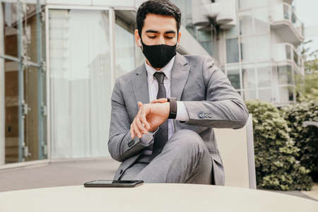 Headshot of a handsome young businessman wearing face mask. Health and selfceare
