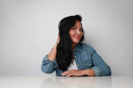 Portrait of beautiful and happy middle age woman on a white background.