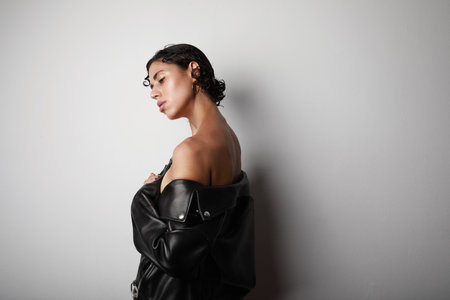 Profile portrait of young confident woman looking aside on white background.の写真素材