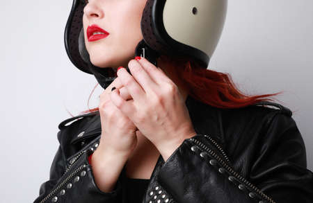 Cropped portrait of young woman with red lips in black leather jacket. Isolated.の写真素材