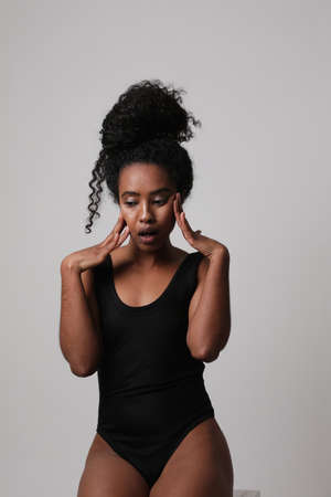 Beautiful African American woman smiling and poses to the camera. Vertical.の写真素材