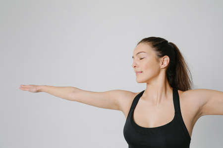 Cropped photo of sporty woman doing yoga practice isolated on white background.の写真素材