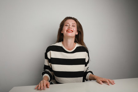 Confident pretty young woman looking at the camera, posing indoor. Isolated.の写真素材
