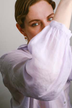 Gorgeous chic woman shining make-up wearing golden jewels. Vertical.の写真素材