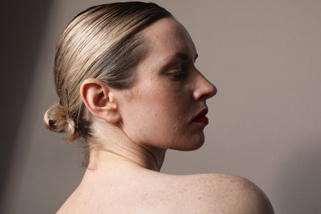 Close-up of young attractive woman with perfect skin and red lips posing indoor.の写真素材