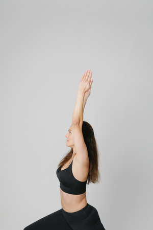 Young woman doing yoga practice isolated on white background. Healthy life.