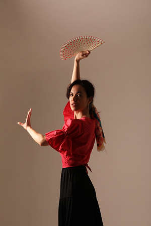 Portrait of flamenco female dancer posing in the white background. Vertical.の写真素材
