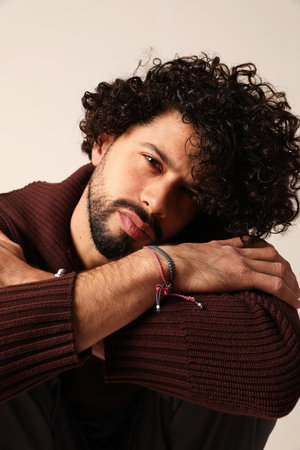 Vertical portrait of casual guy, with curly hair looking at the camera.の写真素材