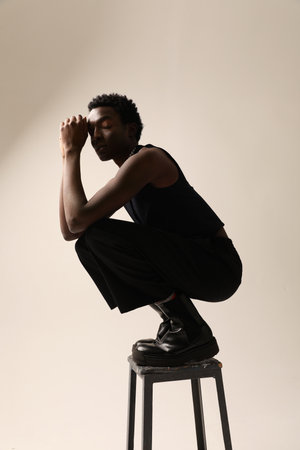 Confident young African American man posing indoor. Vertical mock-up.の写真素材