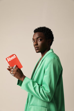 Confident man reading a small red book. Life is a knowledge. Vertical mock-up.の写真素材