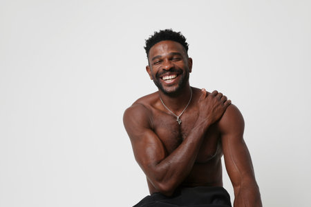 Portrait of overjoyed dark skinned man. Good emotions concept. Mock-up.の写真素材