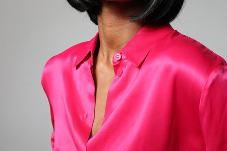 Cropped portrait of pretty young woman body part wearing silk blouse. Mock-up.の写真素材