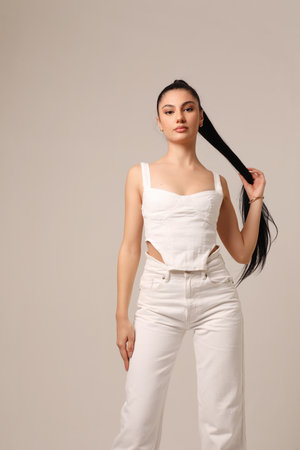 Hair care and skin health. Beautiful woman with long dark hair poses indoor.の写真素材