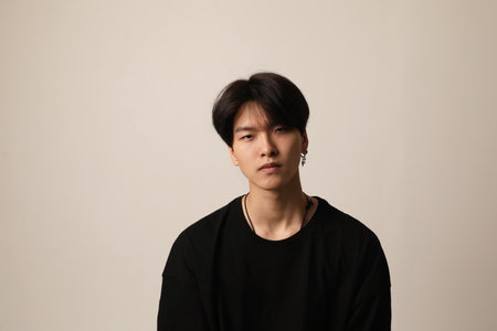 Sad young asian man posing on the white background. Mental health issues.の写真素材